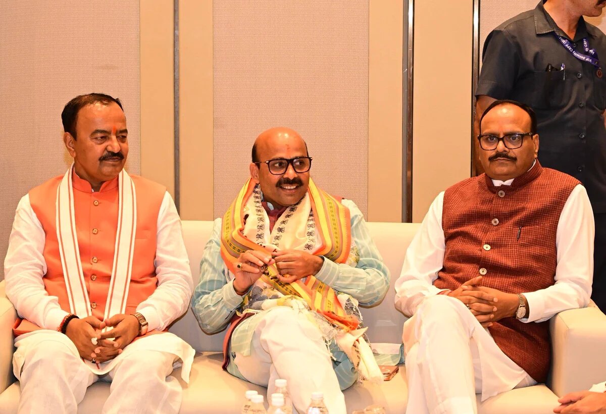 Harish Dwivedi seated with colleagues at a formal occasion