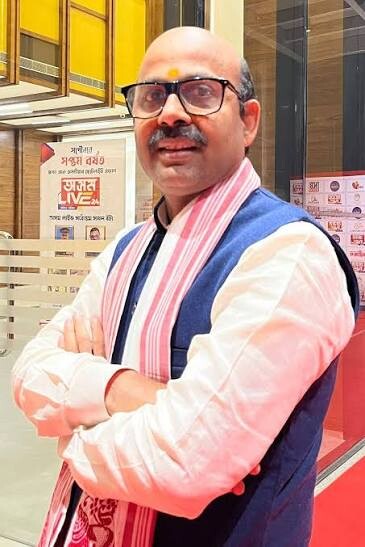 Harish Dwivedi standing at the entrance of a news media office