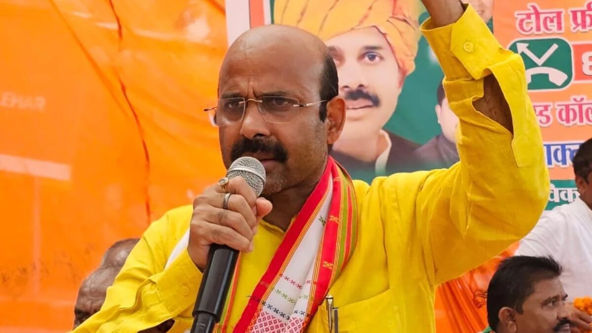 Harish Dwivedi addressing a public gathering with a microphone
