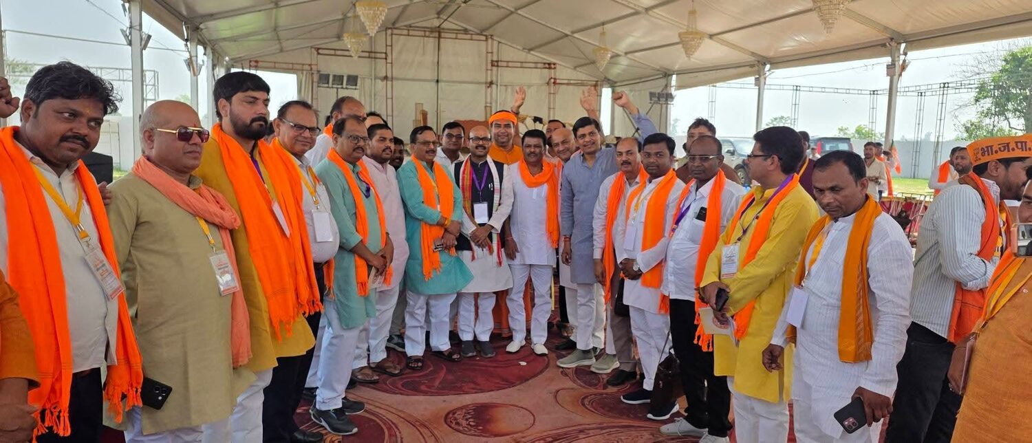 Harish Dwivedi with a large group of party workers gathered under a marquee