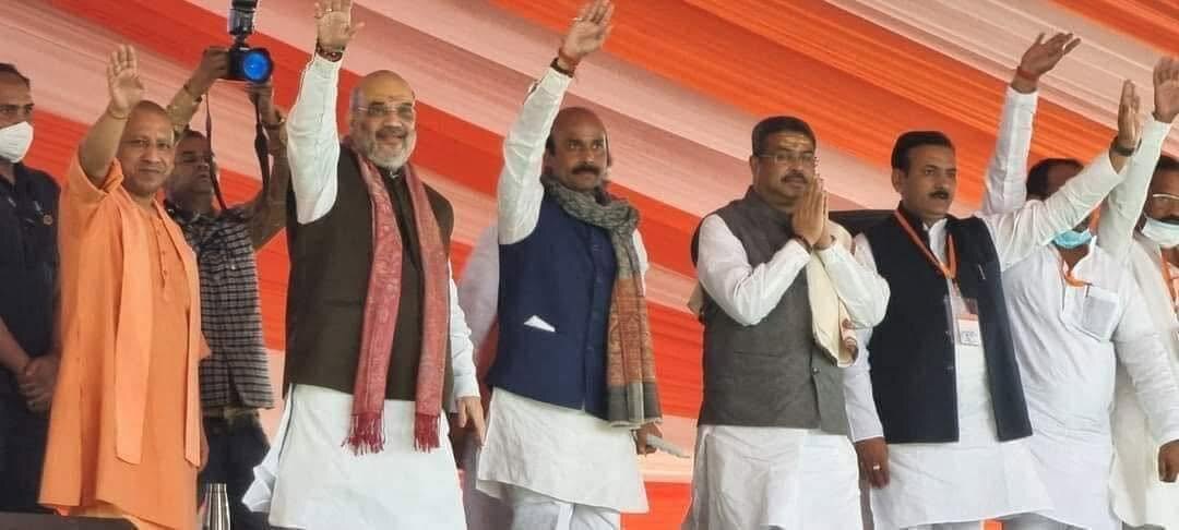 Harish Dwivedi on a public stage with senior party leaders acknowledging a gathering