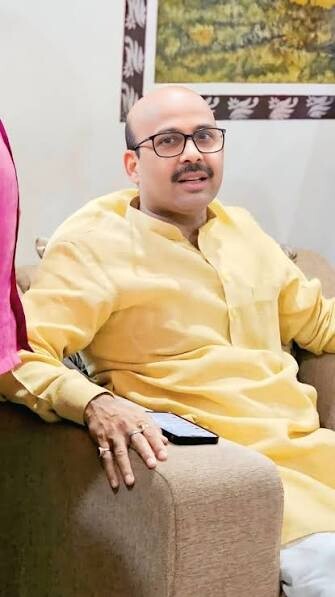 Harish Dwivedi seated in a relaxed setting wearing a yellow kurta